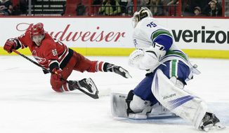 Carolina Hurricanes&#39; Teuvo Teravainen (86), of Finland, tries to score against Vancouver Canucks goalie Jacob Markstrom (25), of Sweden, during the second period of an NHL hockey game in Raleigh, N.C., Friday, Feb. 9, 2018. (AP Photo/Gerry Broome)