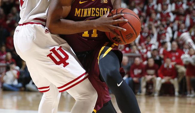 Minnesota guard Isaiah Washington, right, drives around Indiana guard Josh Newkirk during the first half of an NCAA college basketball game in Bloomington, Ind., Friday, Feb. 9, 2018. (AP Photo/AJ Mast)