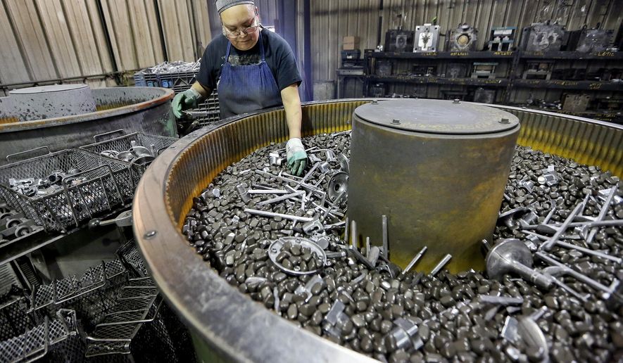 In this Thursday, Jan. 25, 2018 photo, Oralia Aranda works at a vibratory deburring machine at Lund Manufacturing in Farley, Iowa. At Lund Manufacturing, employees routinely carry out the critical and complex tasks that make it possible for clients to create their end products. Vice President Jamie Lund said such a role is common for companies that specialize in die casting. The business creates parts that contribute to stationary bikes, theater lighting and engines. Recently, demand for the company's services is on the rise. (Nicki Kohl/Telegraph Herald via AP)
