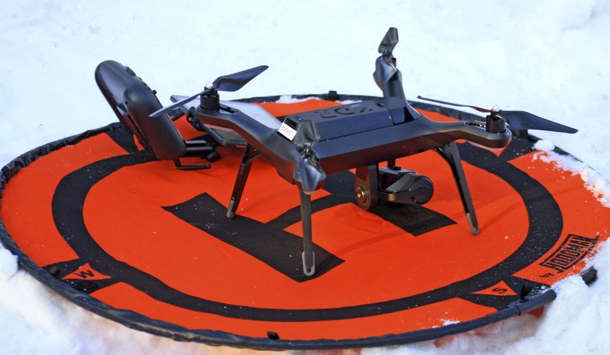 In this Feb. 1, 2018, photo, a 3DR surveillance drone is photographed in a prescribed burn area in the Kenai National Wildlife Refuge during a hazardous fuel reduction project along Funny River Road in Sterling, Alaska. The drone is equipped with thermal sensors that find any hotspots left by the fires. (Erin Thompson/Peninsula Clarion via AP)