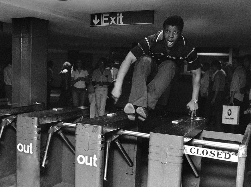 FILE- In this June 27, 1980 file photo, a man jumps a turnstile in the New York City subway system. New York City police and transit officials say a new policy not to prosecute subway fare jumpers could embolden criminals and cause chaos. But Manhattan prosecutors say their policy that took effect this month makes sense because two-thirds of those arrested in for the crime in the borough had no prior convictions. (AP Photo/Ron Frehm, File)