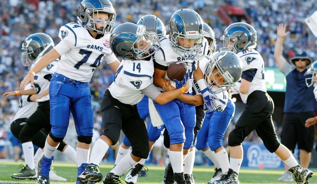 age old: Tackle football would be banned for children younger than 14 under a bill filed in the Maryland General Assembly. Critics say it amounts to government overreach, but supporters say children&#x27;s well-being should come first. (Associated Press)