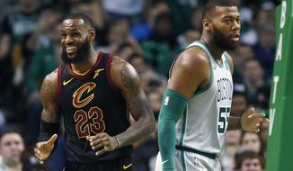Cleveland Cavaliers&#x27; LeBron James (23) reacts to a call beside Boston Celtics&#x27; Greg Monroe (55) during the second quarter of an NBA basketball game in Boston, Sunday, Feb. 11, 2018. (AP Photo/Michael Dwyer)