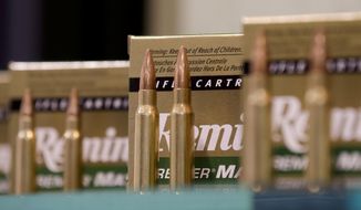 In this Jan. 15, 2013, file photo, Remington rifle cartridges are displayed at the 35th annual SHOT Show in Las Vegas. On March 14, 2019, the Connecticut Supreme Court ruled that a lawsuit by families of Sandy Hook school massacre victims against the gun maker can proceed. (AP Photo/Julie Jacobson, File)