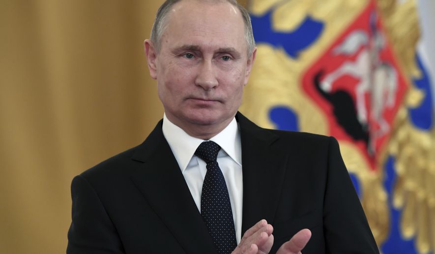 Russian President Vladimir Putin applauds during an award ceremony in the Kremlin, in Moscow, Russia, Thursday, Dec. 28, 2017, for Russian Armed Forces service personnel who took part in the anti-terrorist operation in Syria. Putin said at Thursday&#x27;s award ceremony that Wednesday&#x27;s explosion at a supermarket in the country&#x27;s second-largest city was a terrorist attack. (Kirill Kudryavtsev/Pool Photo via AP)