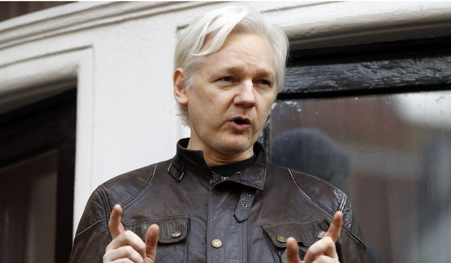 In this May 19, 2017, file photo, WikiLeaks founder Julian Assange gestures to supporters outside the Ecuadorian Embassy in London, where he has been in self-imposed exile since 2012. (AP Photo/Frank Augstein, File)