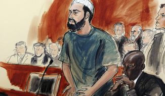In this courtroom drawing, defendant Ahmad Khan Rahimi reads a statement to the judge during his sentencing hearing in New York, Tuesday, Feb. 13, 2018. Rahimi was sentenced to multiple terms of life in prison for setting off small bombs in two states, including a pressure cooker device that blasted shrapnel across a New York City block. At right is attorney Xavier Donaldson, Rahmin&#39;s attorney. (Elizabeth Williams via AP)