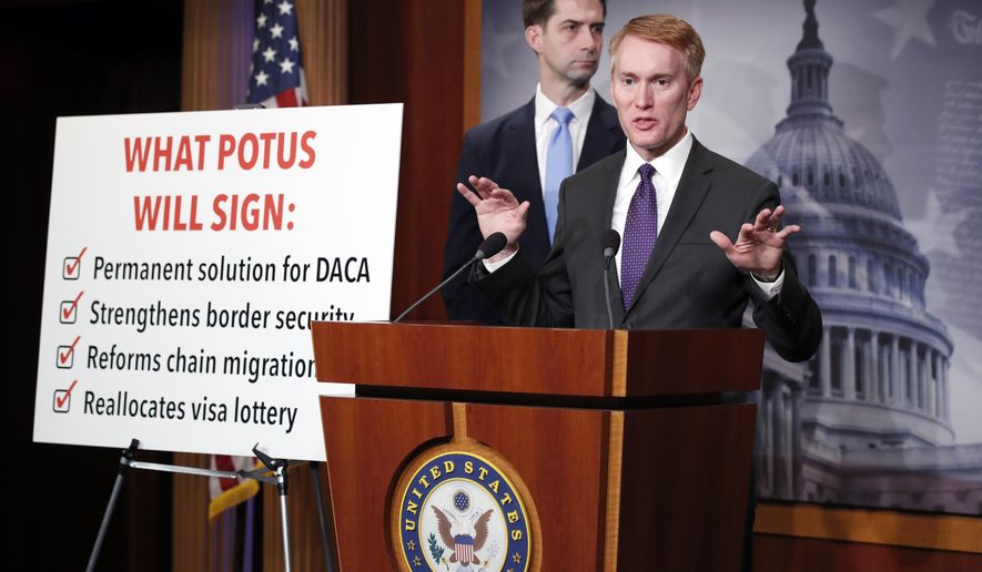 Sen. Tom Cotton, R-Ark., stands at left as Sen. James Lankford, R-Okla., speaks during a news conference about an immigration bill on Capitol Hill, Monday, Feb. 12, 2018 in Washington. (AP Photo/Alex Brandon)