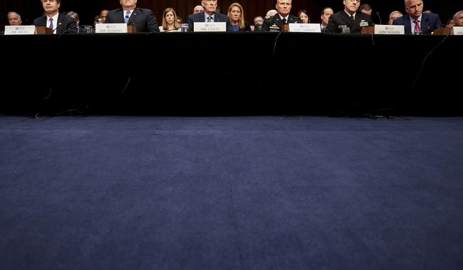 From left, FBI Director Christopher Wray, CIA Director Mike Pompeo, Director of National Intelligence Dan Coats, Defense Intelligence Agency Director Robert Ashley, National Security Agency Director Adm. Michael Rogers, and National Geospatial-Intelligence Agency Director Robert Cardillo, appear before a Senate Select Committee on Intelligence hearing on worldwide threats, Tuesday, Feb. 13, 2018, in Washington. (AP Photo/Andrew Harnik)