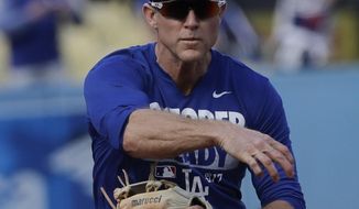 FILE - This Nov. 1, 2017 file photo shows Los Angeles Dodgers&#39; Chase Utley warming up before Game 7 of baseball&#39;s World Series against the Houston Astros in Los Angeles. Utley appears headed back to the Los Angeles Dodgers. The free-agent infielder’s gloves and cleats were in the Dodgers clubhouse on Tuesday, Feb. 13, 2018 and mail addressed to him was in a dressing stall. (AP Photo/David J. Phillip, file)