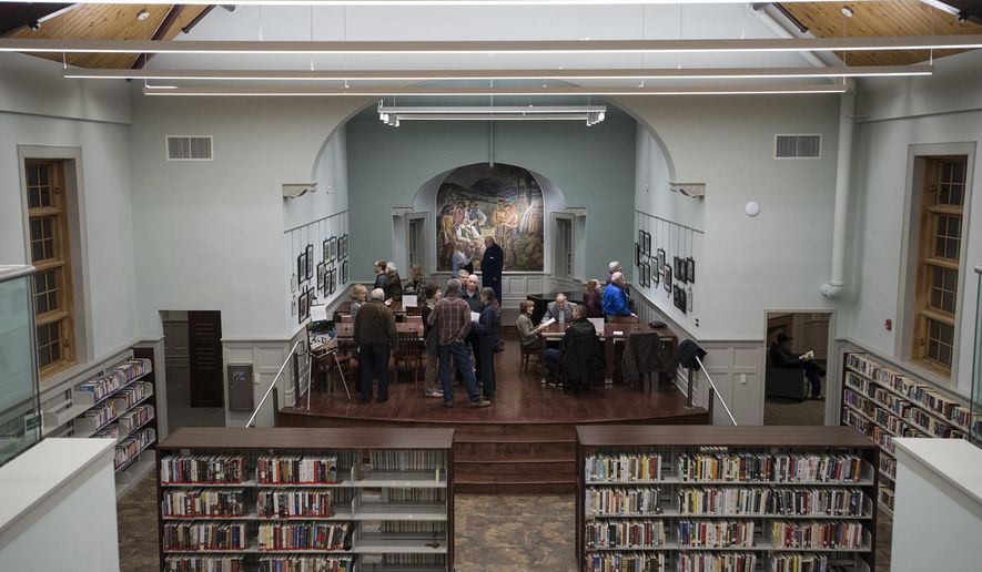 This photo taken Feb. 1, 2018, shows the newly-renovated Oakland Library. More than 19 years and six directors in the making, the borough's original library building has finally re-opened. The two-story structure - boarded up the last 15 years without heat - has received a complete face-lift, including restoration of a New Deal-era mural by Russian-born artist Giorgi Manuilov of Dutch businessmen buying 5,000 acres of Oakland-area property from the Minsi Indians. (Michael Karas/The Record via AP)