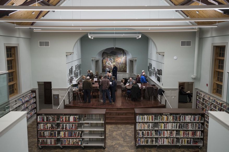 This photo taken Feb. 1, 2018, shows the newly-renovated Oakland Library. More than 19 years and six directors in the making, the borough's original library building has finally re-opened. The two-story structure - boarded up the last 15 years without heat - has received a complete face-lift, including restoration of a New Deal-era mural by Russian-born artist Giorgi Manuilov of Dutch businessmen buying 5,000 acres of Oakland-area property from the Minsi Indians. (Michael Karas/The Record via AP)