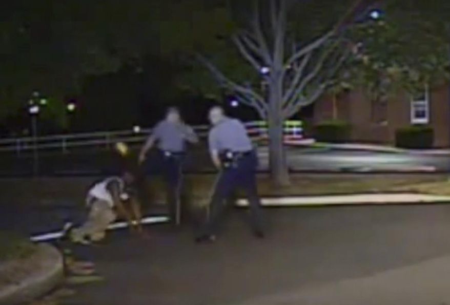 FILE - In this Aug. 24, 2013, file photo made from a police dash camera video and released by the Dover Police Department, Dover Police officer Thomas Webster, center, kicks Lateef Dickerson in the face as Dickerson is following orders to get on the ground during an arrest in Dover, Delaware. Webster, who was acquitted of assaulting the suspect in 2013 has been hired at a Maryland police department, pending state training and certification. Town Manager Jeannette DeLude tells the Delaware State News Thomas W. Webster IV, of Delaware, is in the process of becoming the Town of Greensboro's fourth police officer. DeLude says Webster was the most qualified applicant. (Dover Police Department via AP, File)