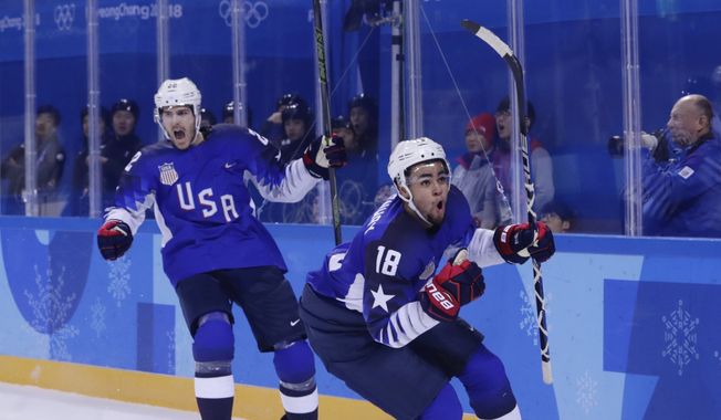 Jordan Greenway (18), of the United States, celebrates with teammate Bobby Sanguinetti (22) after scoring a goal during the second period of the preliminary round of the men&#x27;s hockey game against Slovenia at the 2018 Winter Olympics in Gangneung, South Korea, Wednesday, Feb. 14, 2018. (AP Photo/Frank Franklin II)