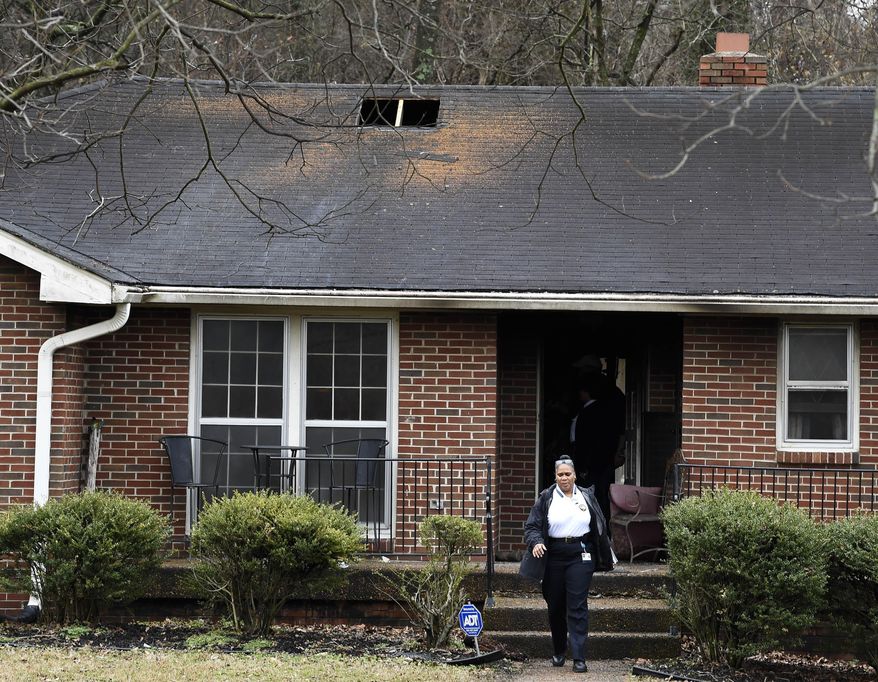 Investigators inspect the house where three people were killed in a fire in Nashville, Tenn., Wednesday, Feb. 14, 2018. (Lacy Atkins/The Tennessean via AP)