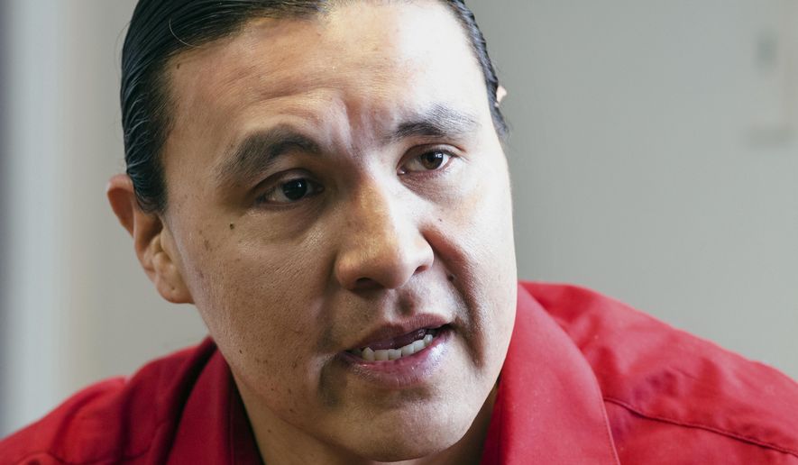 FILE - In this Feb. 6, 2014, file photo, Chase Iron Eyes, an attorney and American Indian activist on the Standing Rock Reservation, speaks in Fort Yates, N.D. Iron Eyes, who is accused of inciting a riot during protests in North Dakota against the Dakota Access oil pipeline, wants a judge to force prosecutors to obtain and turn over evidence from private security firms. The request contends private security workers acted as agents of the state, making the government obligated to turn over evidence from them. His trial is scheduled for August 2018. (AP Photo/Kevin Cederstrom, File)