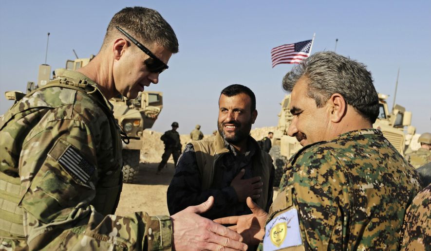 FILE - This Wednesday, Feb. 7, 2018 file photo, shows U.S. Army Maj. Gen. Jamie Jarrard left, thanks Manbij Military Council commander Muhammed Abu Adeel near the town of Manbij, northern Syria. As Syrian troops and their allies push toward final victory and the battle against Islamic State militants draws to an end, new fronts are opening up, threatening an even broader confrontation. The U.S., Israel and Turkey all have deepened their involvement, seeking to protect their interests in the new Syria order. (AP Photo/Susannah George, File)