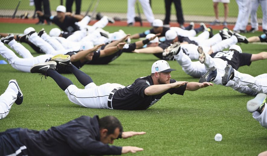 Detroit Tigers pitcher Alex Wilson does an exercise with the rest of the players during spring baseball practice, Wednesday, Feb. 14, 2018 in Lakeland, Fla. (Robin Buckson/Detroit News via AP) ** FILE **