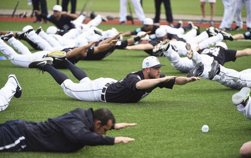 Detroit Tigers pitcher Alex Wilson does an exercise with the rest of the players during spring baseball practice, Wednesday, Feb. 14, 2018 in Lakeland, Fla. (Robin Buckson/Detroit News via AP) ** FILE **