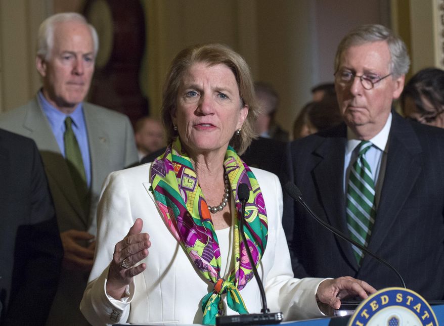 FILE - In this March 17, 2015, file photo, Sen. Shelly Moore Capito, R-W.Va., accompanied by Senate Majority Leader Mitch McConnell of Ky., right, and Senate Majority Whip John Cornyn of Texas, speaks on Capitol Hill in Washington. Prominent Republican women say they’re frustrated by President Donald Trump’s handling of abuse charges against men in the White House’s midst. Moore Capito of West Virginia says it’s difficult being a Republican woman and having to “fight through” the administration’s muddled message to women. (AP Photo/Molly Riley, File)