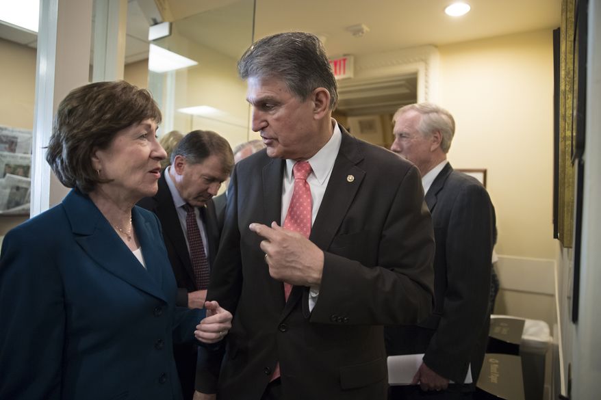 Sen. Susan Collins, R-Maine, left, and Sen. Joe Manchin, D-W.Va., confer just before a news conference on the bipartisan immigration deal they reached with other centrists this week that sought to offer citizenship to young "Dreamer" immigrants and President Donald Trump's demands for billions to build a border wall with Mexico, at the Capitol in Washington, Thursday, Feb. 15, 2018. The Trump administration is already denouncing their deal in the Senate, saying it will "create a mass amnesty for over 10 million illegal aliens, including criminals." (AP Photo/J. Scott Applewhite)