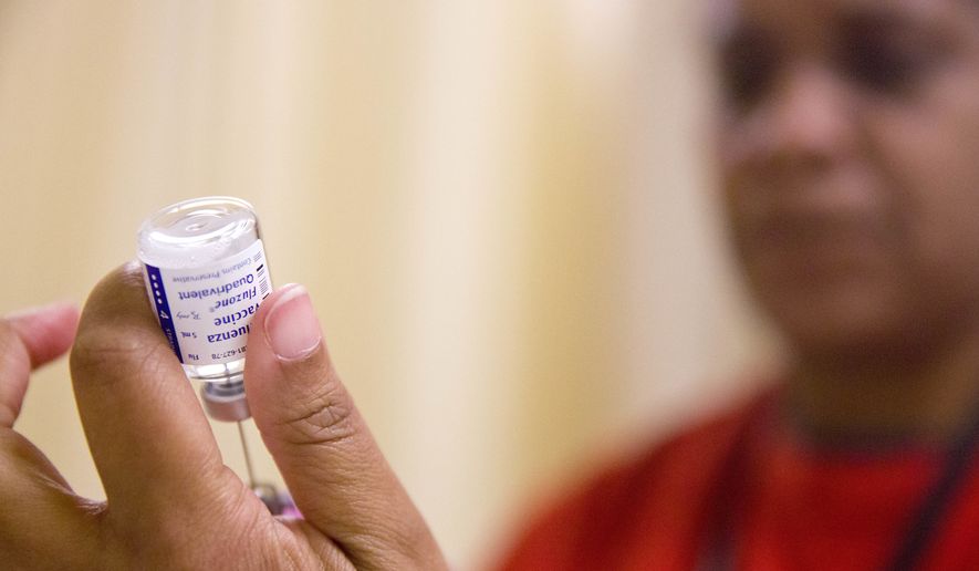 In this Wednesday, Feb. 7, 2018 file photo, a nurse prepares a flu shot from a vaccine vial at the Salvation Army in Atlanta. (AP Photo/David Goldman) **FILE**