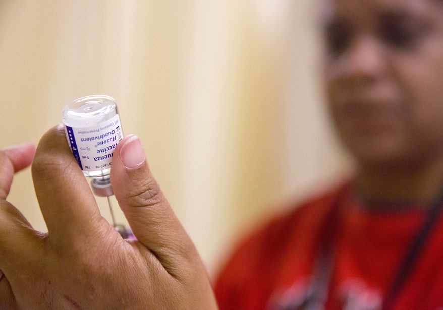 In this Wednesday, Feb. 7, 2018 file photo, a nurse prepares a flu shot from a vaccine vial at the Salvation Army in Atlanta. (AP Photo/David Goldman) **FILE**
