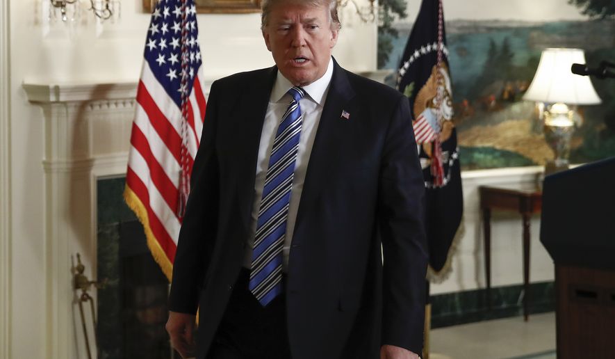 President Donald Trump walks from the Diplomatic Room of the White House, in Washington, Thursday, Feb 15, 2018, after speaking about the tragic shooting in Parkland, Fla. (AP Photo/Carolyn Kaster)