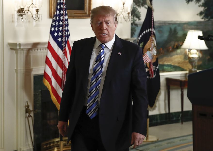 President Donald Trump walks from the Diplomatic Room of the White House, in Washington, Thursday, Feb 15, 2018, after speaking about the tragic shooting in Parkland, Fla. (AP Photo/Carolyn Kaster)