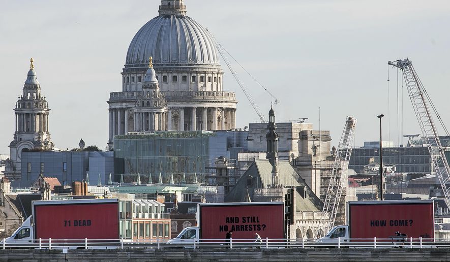 The Community-led organisation, Justice4Grenfell, parades three billboards backdropped by St. Paul's Cathedral as they move around London, Thursday Feb. 14, 2018, calling for justice for the victims of the June 14, 2017, deadly apartment fire. Campaigners for victims of the deadly London Grenfell Tower high-rise apartment fire have taken inspiration from an Academy Award-nominated film to press for more action by police. (Jeff Moore/Justice4Grenfell via AP)