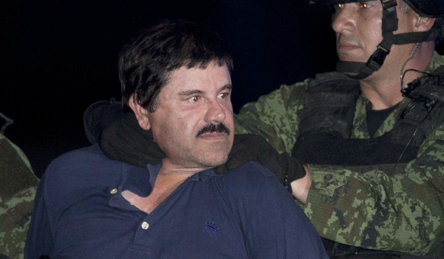 FILE - In this Jan. 8, 2016, file photo, Mexican drug lord Joaquin "El Chapo" Guzman is made to face the press as he is escorted to a helicopter in handcuffs by Mexican soldiers and marines at a federal hangar in Mexico City, Mexico. Notorious Mexican drug lord and escape artist Joaquin "El Chapo" Guzman is eager to go to trial, his lawyer said Thursday, Feb. 15, 2018 after a U.S. judge set Sept. 5 for jury selection in his drug-trafficking case. (AP Photo/Marco Ugarte, File)