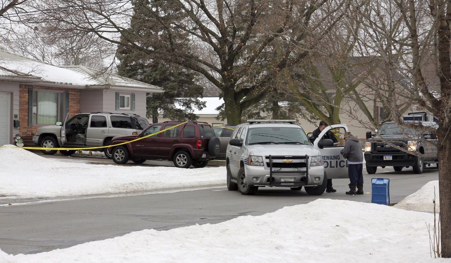 Sebewaing Police Department investigate the scene of a homicide on Thursday, Feb. 15, 2018 in Sebewaing, Mich., Feb. 15, 2018. Police say they believe a man killed his wife and adult daughter at a Michigan home before fatally shooting himself. (Brenda Battel/The Huron Daily Tribune via AP)