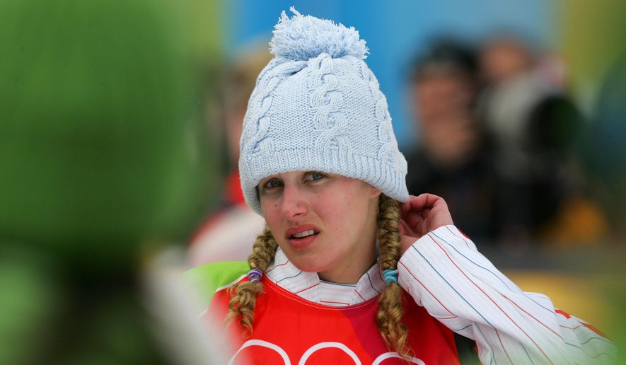 FILE - In this Friday, Feb. 17, 2006 file photo, silver medallist Lindsey Jacobellis, of the United States, reacts prior to the flower ceremony of the Women&#39;s Snowboard Cross competition at the Turin 2006 Winter Olympic Games in Bardonecchia, Italy.  Jacobellis says she’s long since moved past her misstep that cost her a gold medal at the 2006 Olympics. Jacobellis was leading in the women’s snowboardcross finals when she fell after trying to showboat a bit on her way to the finish line. The mistake forced her to settle for silver. (AP Photo/Peter Dejong, File)