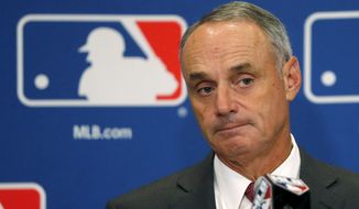 FILE - In this Aug. 17, 2017, file photo, Commissioner Rob Manfred listens to a question following the two-day meeting of Major League Baseball owners in Chicago. Baseball Commissioner Rob Manfred says proposed rules changes to speed pace of play with be in place by the start of big league exhibition games on Feb. 23, 2018. Speaking Thursday, Feb. 15, 2018 at Tropicana Field, Manfred says “one way or the other&#39;&#39; there will be rule changes. (AP Photo/Charles Rex Arbogast, File)