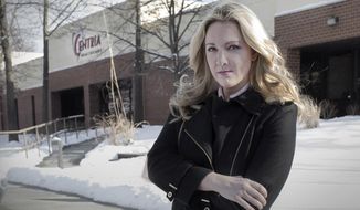 In a Wednesday, Feb. 7, 2018 photo, Vanessa Pawlak, former chief compliance officer for Centria, who was fired from her job after notifying company board members Centria was not in compliance with federal and state laws concerning Medicaid billing, certification of employees and other regulatory issues, is seen outside company offices in Novi, Mich.  (Kathleen Galligan/Detroit Free Press via AP)