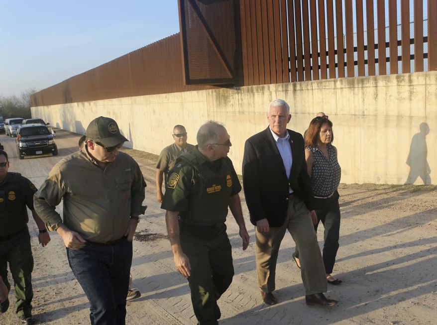 Vice President Mike Pence, second from right, listens to Manuel Padilla, center, U.S. Border Patrol Rio Grande Valley sector chief, while touring the border wall with Sen. Ted Cruz and wife Karen Pence, Friday, Feb. 16, 2018, in Hidalgo, Texas. Pence spent the afternoon touring the U.S.-Mexico border with and talking with federal law enforcement officers on their efforts to secure the border. (Nathan Lambrecht/The Monitor via AP) AP)