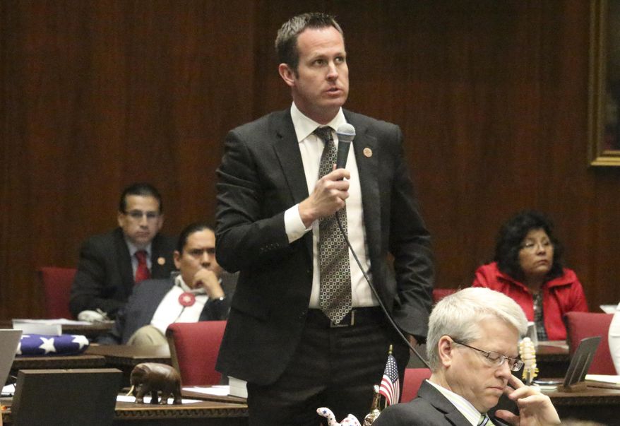 In this Feb. 1, 2018 photo Republican Rep. Travis Grantham speaks on the floor of the Arizona House in Phoenix, Ariz. Grantham is sponsoring legislation requiring state universities and community colleges to allow students and staff to carry non-lethal weapons such as pepper spray and stun guns that passed the House on Thursday, Feb. 15, 2018. (AP photo/Bob Christie)