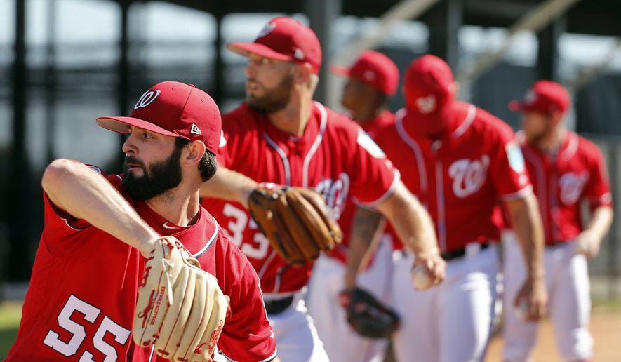 Washington Nationals pitchers, including Tim Collins (55) and Matt Grace (33) throw in the bullpen during spring training baseball practice Saturday, Feb. 17, 2018, in West Palm Beach, Fla. (AP Photo/Jeff Roberson) ** FILE **