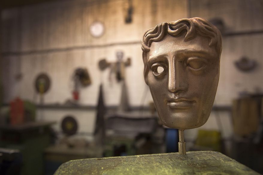 FILE - In this Tuesday, Jan. 31, 2017 file photo, a bronze alloy BAFTA mask stands in a foundry in West Drayton, London, ahead of the award ceremony in February. Designed by US sculptor Mitzi Cunliffe in 1955, New Pro Foundries has been making the bronze casts since the ceremony was created in 1976. The red carpet will be a sea of black as the movement against sexual misconduct takes center stage at the British Academy Film Awards on Sunday Feb. 18, 2018. (Photo by Joel Ryan/Invision/AP, File)
