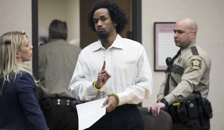 Mahad Abdiraham raises his index finger as he was photographed leaving the courtroom after his sentencing, Friday, Feb. 16, 2018 at the Hennepin County Government Center in Minneapolis. Abdiraham, a 20-year-old Minneapolis man has been sentenced to 15 years in prison for attacking two brothers at the Mall of America. (Renee Jones Schneider/Star Tribune via AP)