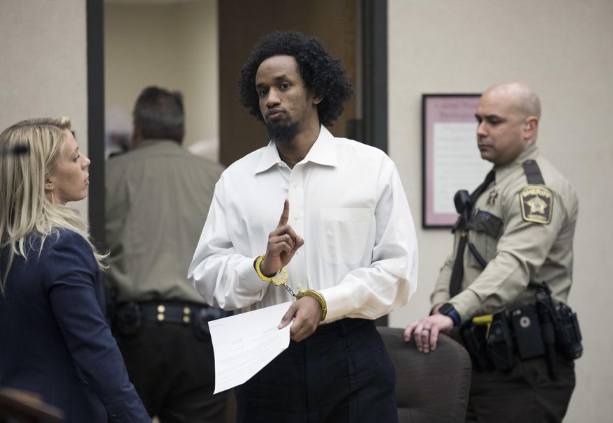Mahad Abdiraham raises his index finger as he was photographed leaving the courtroom after his sentencing, Friday, Feb. 16, 2018 at the Hennepin County Government Center in Minneapolis. Abdiraham, a 20-year-old Minneapolis man has been sentenced to 15 years in prison for attacking two brothers at the Mall of America. (Renee Jones Schneider/Star Tribune via AP)