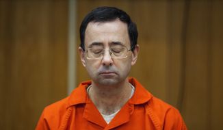 FILE - In this Feb. 5, 2018, file photo, Larry Nassar listens during his sentencing at Eaton County Circuit Court in Charlotte, Mich. Right in the midst of the Pyeongchang Games, with hardly enough time for Larry Nassar to settle into the prison cell where he&#39;ll be spending the rest of his life, we got another report detailing horrific abuse and shameful cover-ups within one of the most high-profile summer sports. (Cory Morse/The Grand Rapids Press via AP, File)