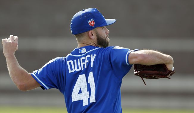 Kansas City Royals pitcher Danny Duffy throws during a baseball spring training workout, Saturday, Feb. 17, 2018, in Surprise, Ariz. (AP Photo/Charlie Neibergall)