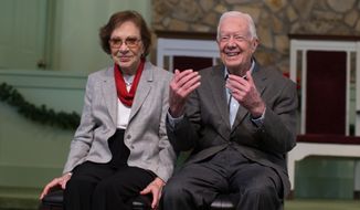 Former President Jimmy Carter, right, sits with his wife, Rosalynn, as they wait to pose for photos with guests at Maranatha Baptist Church,  Sunday, Dec. 13, 2015, in Plains, Ga.  A recent MRI showing no cancer on Jimmy Carter&#39;s brain is &quot;very positive&quot; news for the former president but will not end his medical treatment, doctors said. Carter, 91, announced last Sunday that doctors found no evidence of the four lesions discovered on his brain this summer and no signs of new cancer growth.  (AP Photo/Branden Camp)