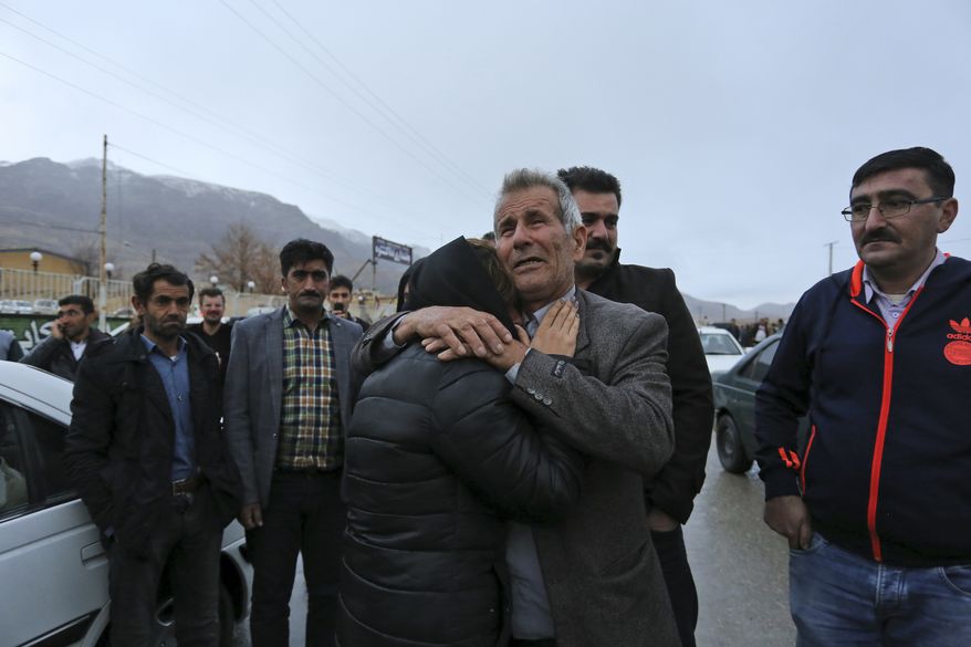 In this photo provided by Tasnim News Agency, family members of plane crash victims weep in the village of Bideh, an area near where the plane crashed, southern Iran, Sunday, Feb. 18, 2018. An Iranian commercial plane crashed Sunday in a foggy, mountainous region of southern Iran, and officials said they feared all people aboard were killed. (Ali Khodaei,Tasnim News Agency via AP)
