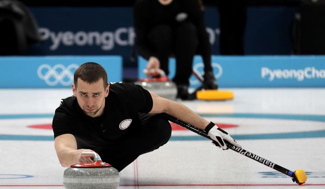 In this Feb. 7, 2018, file photo, Russian curler Alexander Krushelnitsky practices ahead of the 2018 Winter Olympics in Gangneung, South Korea. Russian curlers say a coach on their team told them that mixed doubles bronze medalist Krushelnitsky tested positive for a banned substance at the Pyeongchang Olympics. (AP Photo/Aaron Favila, File)
