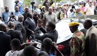 Zimbabwe President Emmerson Mnangagwa, center, leaves after paying his respects to the family of Morgan Tsvangirai, in Harare, Sunday, Feb. 18, 2018. Zimbabwe&#39;s veteran opposition leader Morgan Tsvangirai, aged 65, died Wednesday bringing an end to his long campaign to lead the country. Tsvangirai is set to be buried at his rural home in Buhera on Tuesday. (AP Photo/Tsvangirayi Mukwazhi)