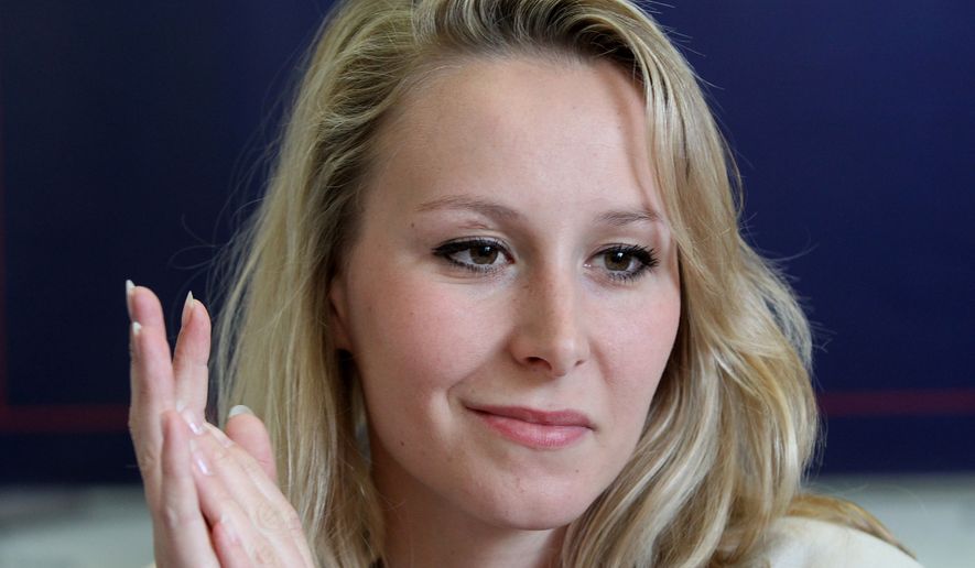 Far-right National Front party regional leader for southeastern France Marion Marechal-Le Pen attends a press conference in Bayonne, southwestern France, Tuesday, April 11, 2017. She is campaigning for far-right candidate for the presidential election Marine Le Pen, seen on poster behind. The top two vote-getters on April 23 will compete in a presidential runoff on May 7. (AP Photo/Bob Edme)