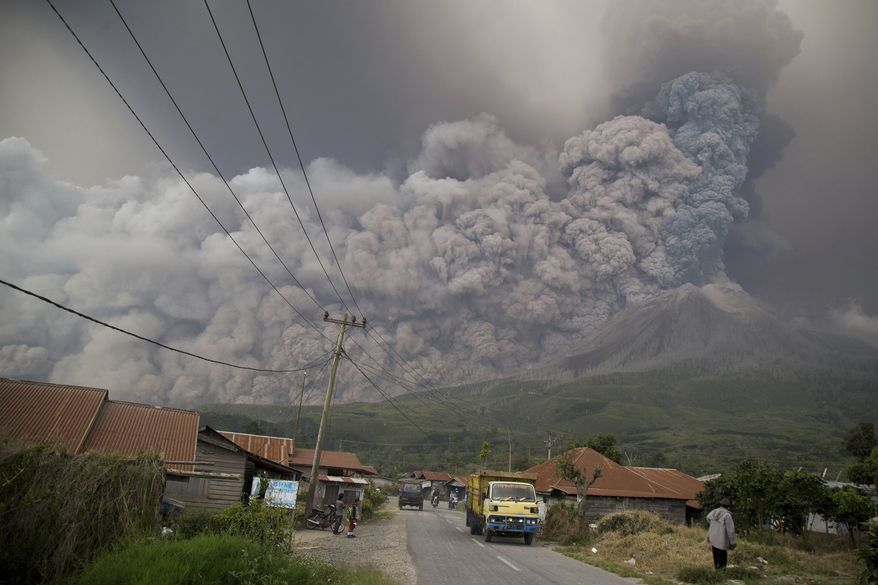 Mount Sinabung spews volcanic ash as it erupts in Kutarakyat, North Sumatra, Indonesia, Monday, Feb. 19, 2018. Rumbling Mount Sinabung on the Indonesian island of Sumatra has shot billowing columns of ash more than 5,000 meters (16,400 feet) into the atmosphere and hot clouds down its slopes. (AP Photo/Endro Rusharyanto)
