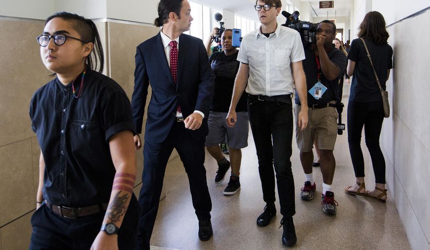 FILE - In a Thursday, Aug. 17, 2017 file photo, from left, Ngoc Loan Tran, 24, Peter Gull Gilbert, 36, and Dante Strobino, 35, leave a courtroom in the Durham County Courthouse after their first court appearance after being arrested for the toppling of the Durham County confederate statue during a protest, in Durham, NC. A North Carolina judge trying protesters accused of toppling a Confederate statue on Monday, Feb. 19, 2018, dismissed the criminal case against Strobino. (Casey Toth/The Herald-Sun via AP, File)